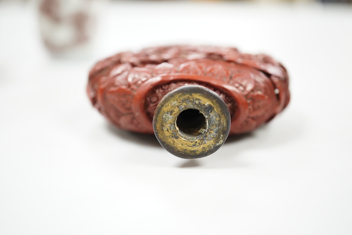 A Chinese cinnabar lacquer snuff bottle, a glass overlay snuff bottle and an underglaze copper red snuff bottle-9cm high (3)